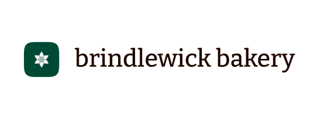 Brindlewick Bakery logo: Bitter 500, horizontal layout, petal symbol, rust and teal and brown