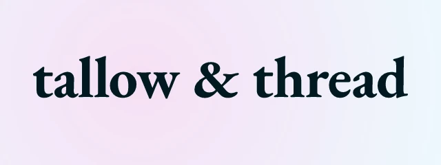 Tallow & Thread logo: EB Garamond 700, wordmark layout, none symbol, navy and pink and yellow