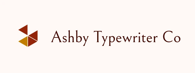 Ashby Typewriter Co logo: Bellefair 400, horizontal layout, prism symbol, rust and gold